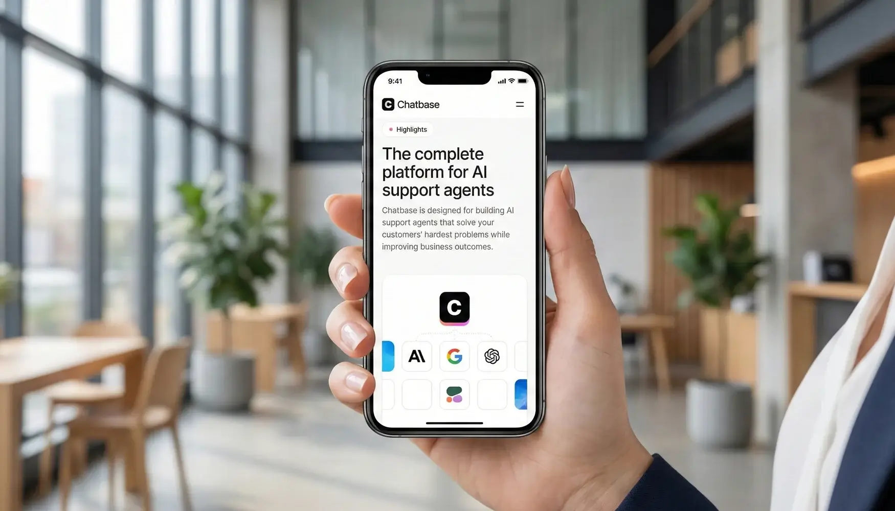 Woman holding an iPhone displaying the Chatbase mobile interface for AI support agents in a modern office setting.